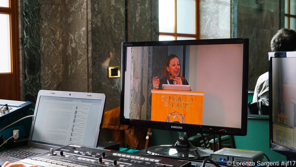 Data analyst reviewing AI‑generated charts on computer screens in a modern office
