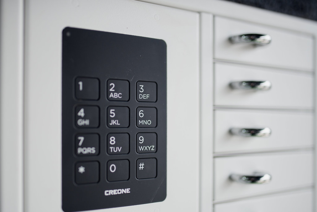 A professional working at a clean, modern desk with technology devices in a well-lit office setting